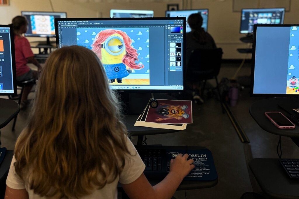Child on computer at Art Squat Teen Art Summer Camp