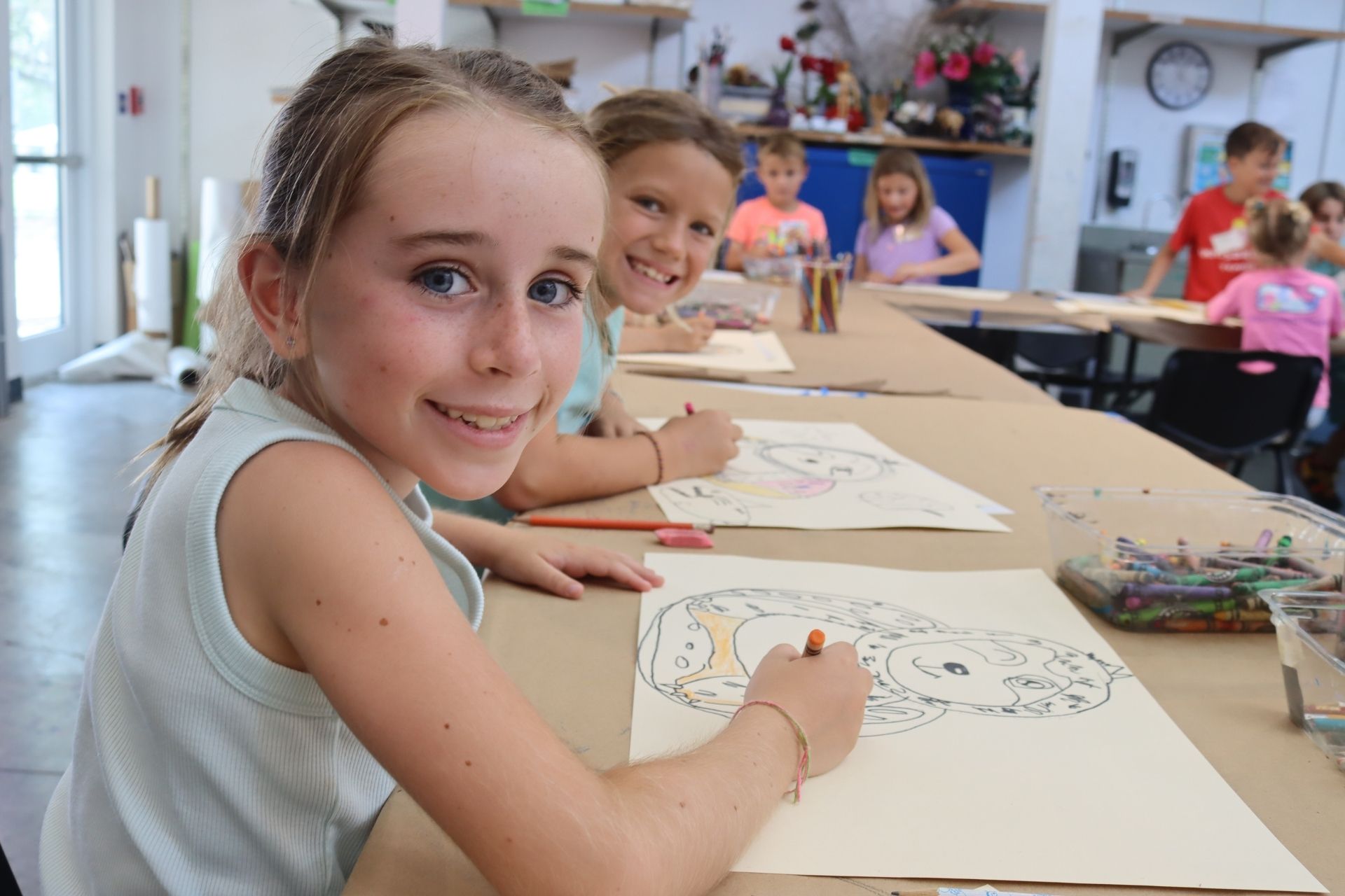 Kids doing art at tables