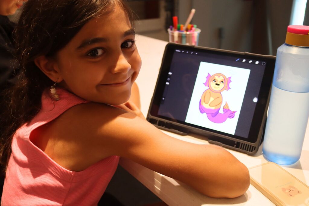 Child using iPad at iPad Explorations Summer Camp