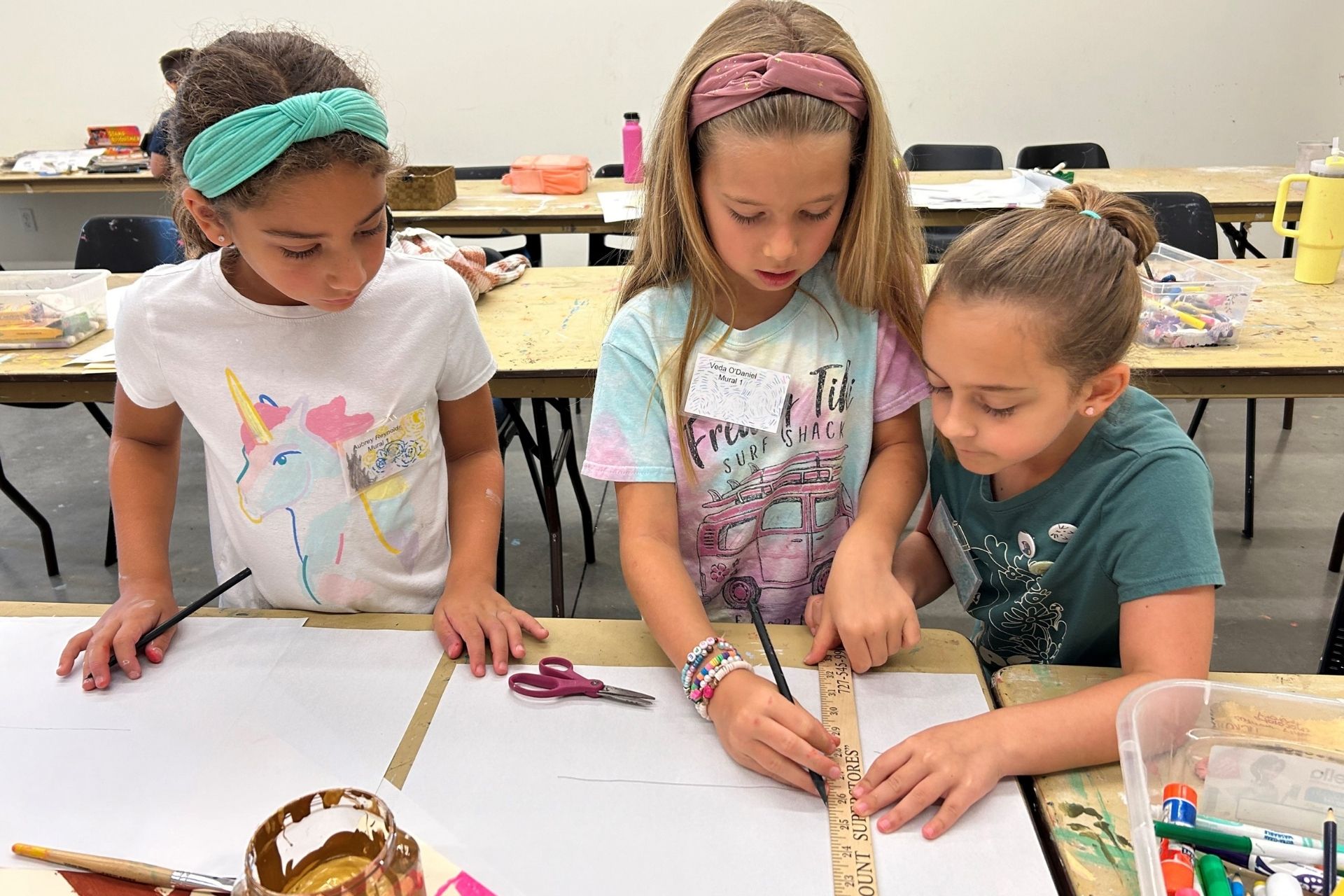 Kids doing art at tables